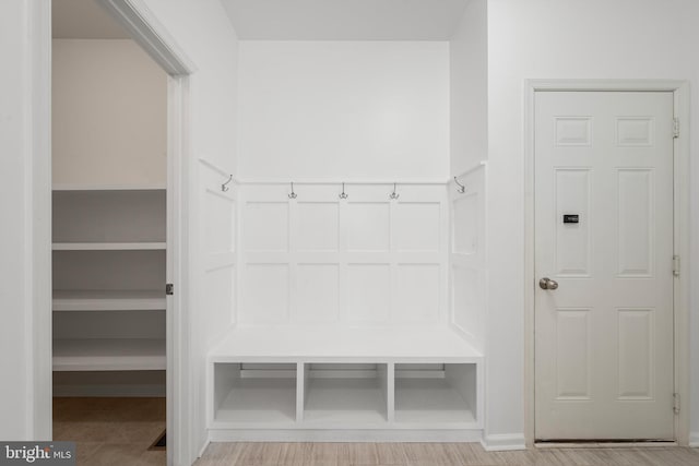 mudroom with wood-type flooring