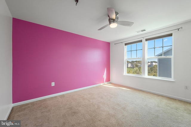 spare room with carpet and ceiling fan