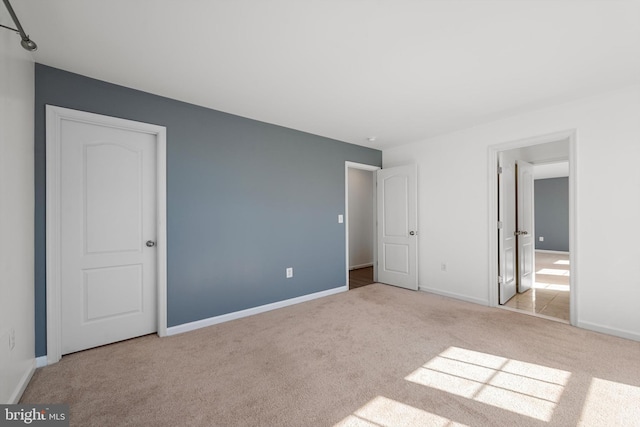 unfurnished bedroom with light carpet