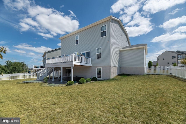 back of house with a yard, a patio area, and a wooden deck