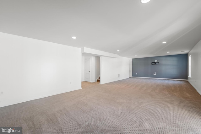 basement featuring light carpet