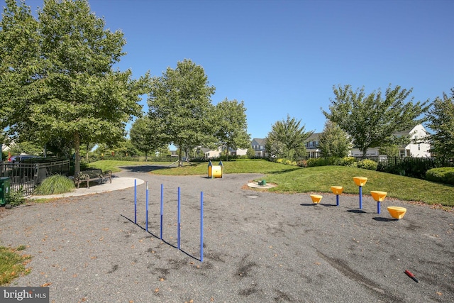 view of home's community featuring a yard and a playground