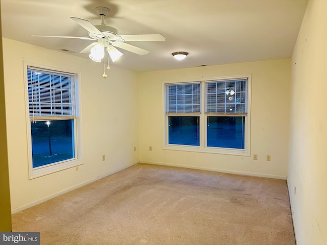 carpeted empty room featuring ceiling fan