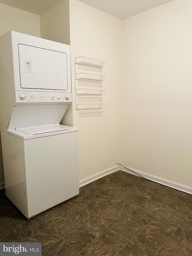 laundry area featuring stacked washing maching and dryer