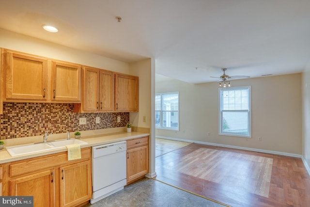 kitchen with ceiling fan, decorative backsplash, sink, light hardwood / wood-style floors, and white dishwasher