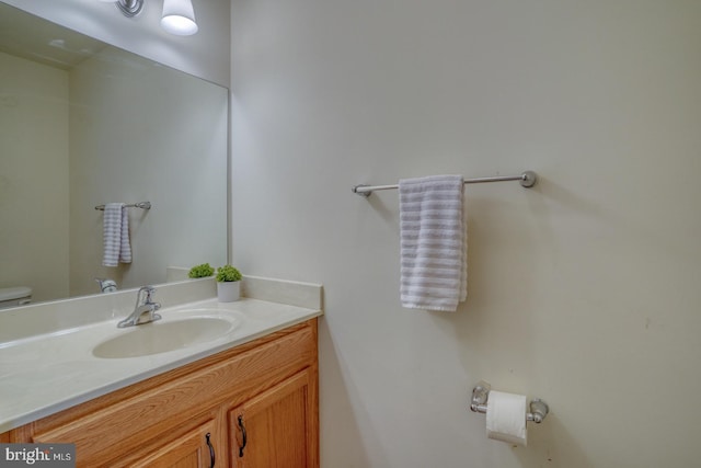 bathroom featuring toilet and vanity