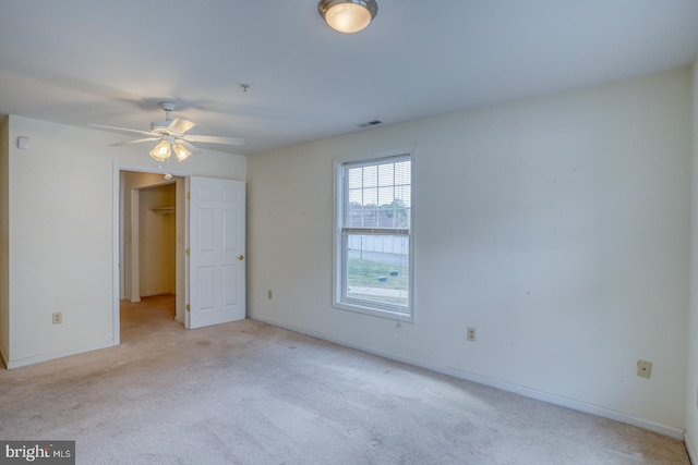 unfurnished room with light carpet and ceiling fan