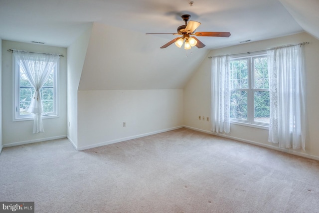 additional living space featuring ceiling fan, light carpet, and vaulted ceiling