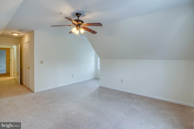 additional living space with light carpet, ceiling fan, and lofted ceiling