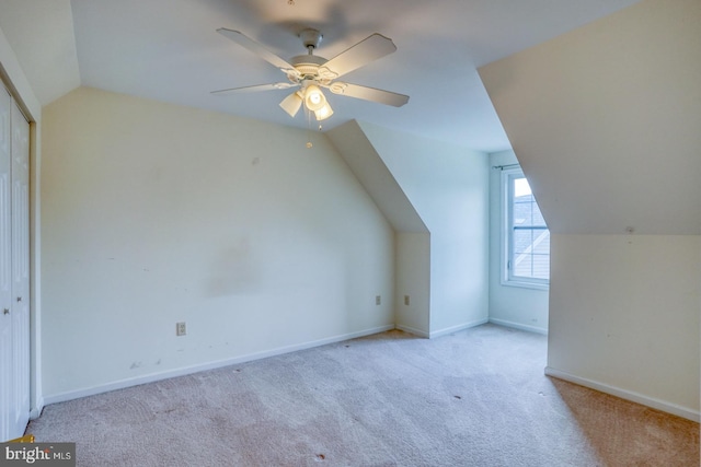 bonus room featuring ceiling fan, light colored carpet, and vaulted ceiling