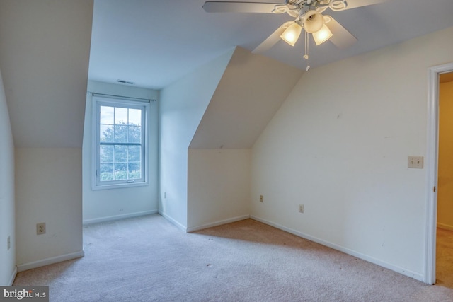 bonus room featuring ceiling fan, light colored carpet, and vaulted ceiling