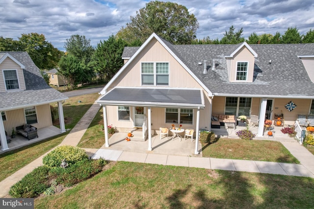 view of front of house with a front yard and a patio