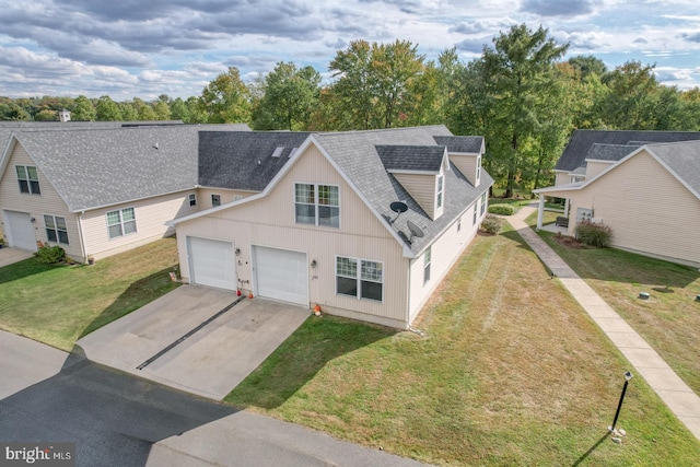 view of front of property with a front lawn and a garage