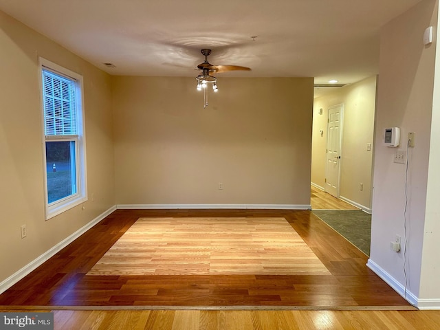 empty room with ceiling fan and hardwood / wood-style floors