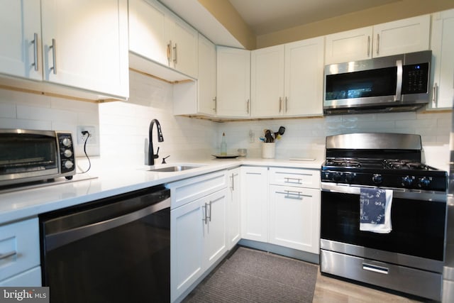 kitchen featuring sink, stainless steel appliances, and white cabinets