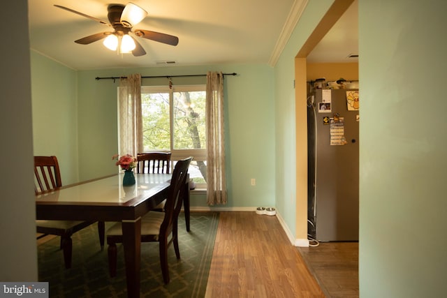 dining area featuring crown molding, ceiling fan, and wood-type flooring