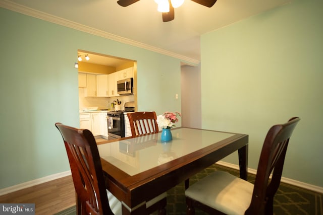 dining room featuring ceiling fan, ornamental molding, and dark hardwood / wood-style flooring