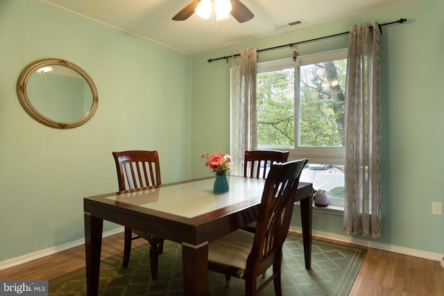 dining room with ceiling fan and hardwood / wood-style floors