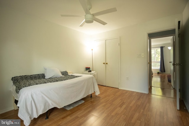 bedroom featuring wood-type flooring, a closet, and ceiling fan