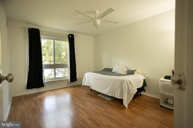 bedroom with hardwood / wood-style floors and ceiling fan