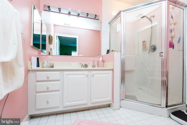 bathroom featuring vanity, tile patterned flooring, and walk in shower