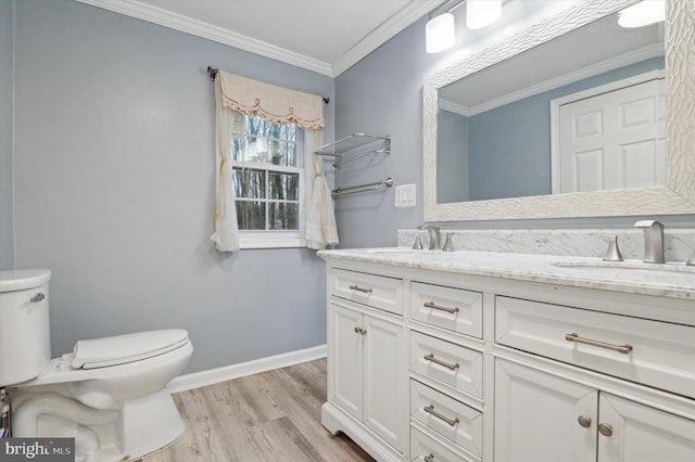 bathroom with vanity, hardwood / wood-style flooring, toilet, and ornamental molding