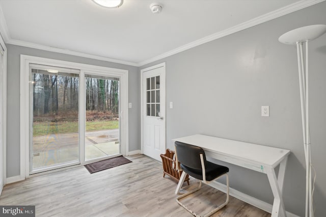 office area with light hardwood / wood-style floors and ornamental molding