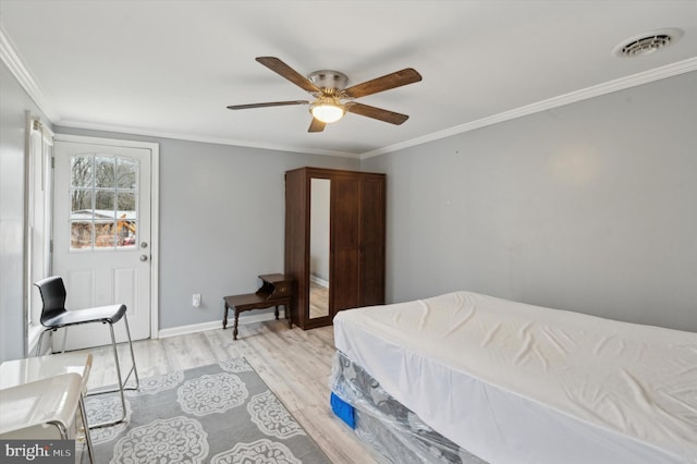 bedroom featuring ceiling fan, ornamental molding, and light wood-type flooring