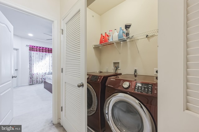 laundry room featuring light colored carpet and washing machine and clothes dryer