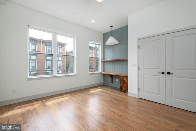 unfurnished bedroom featuring a closet and hardwood / wood-style floors