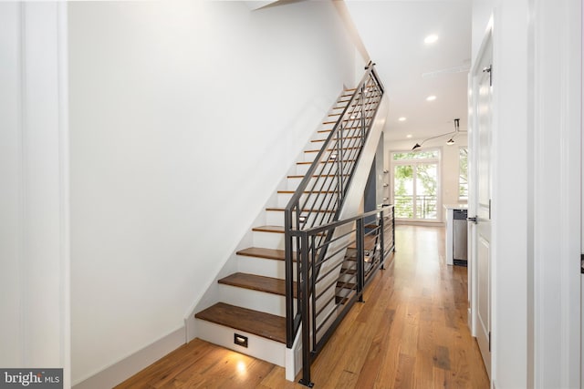 staircase featuring wood-type flooring