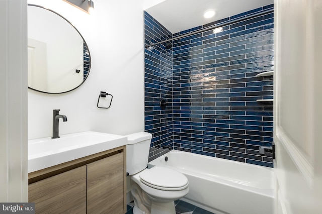 full bathroom with vanity, tiled shower / bath, and toilet