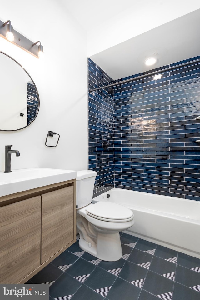 full bathroom featuring vanity, toilet, and tiled shower / bath