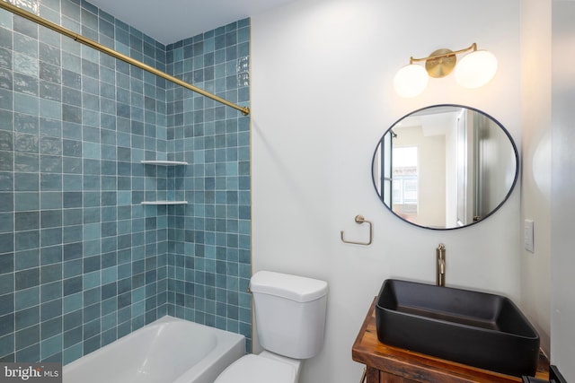 full bathroom with toilet, tiled shower / bath, and vanity