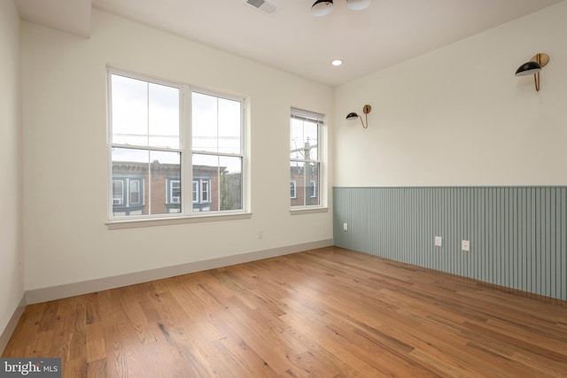 spare room with wood-type flooring