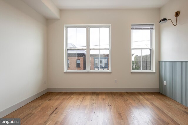 spare room with light hardwood / wood-style floors