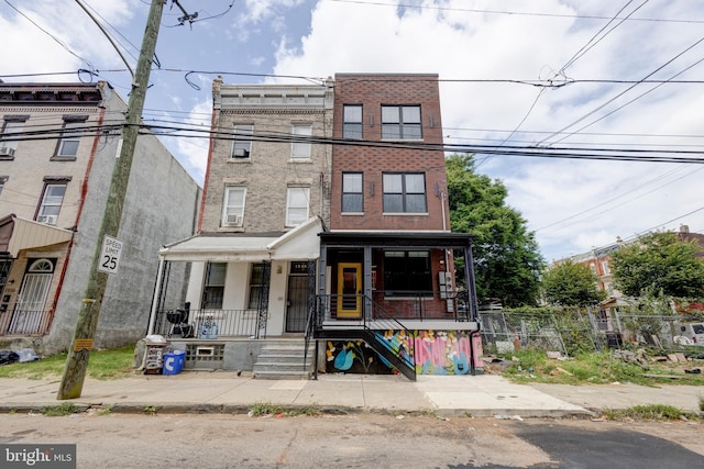 townhome / multi-family property featuring covered porch