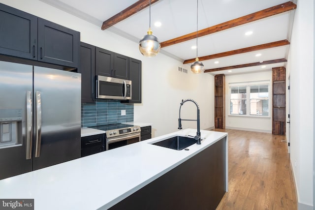 kitchen with beam ceiling, appliances with stainless steel finishes, pendant lighting, light hardwood / wood-style floors, and sink