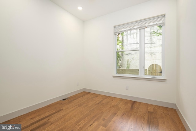 empty room with hardwood / wood-style flooring