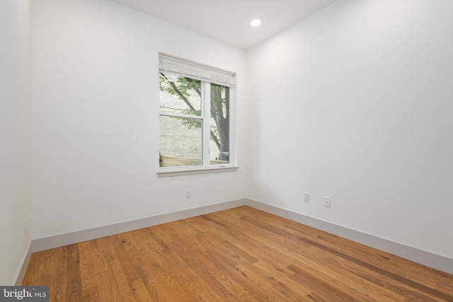 unfurnished room with wood-type flooring