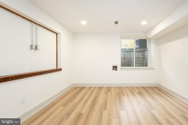 spare room featuring light hardwood / wood-style floors