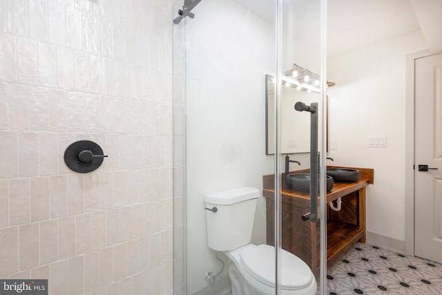 bathroom with vanity, a shower, and toilet