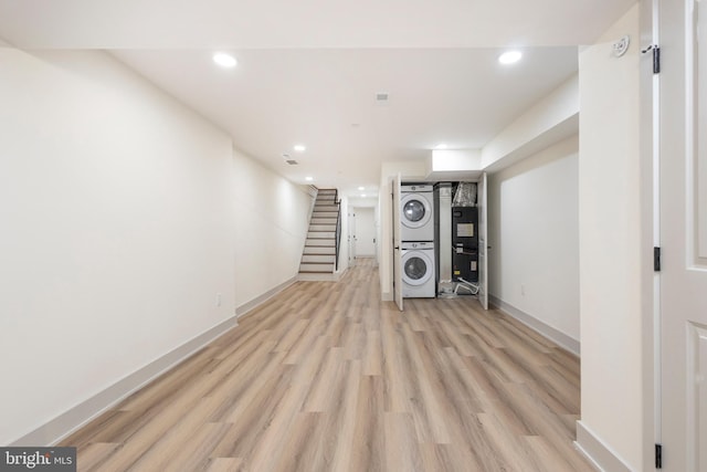 interior space with stacked washer and dryer and light wood-type flooring