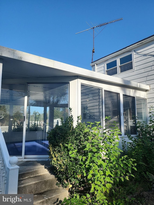 view of patio featuring a sunroom