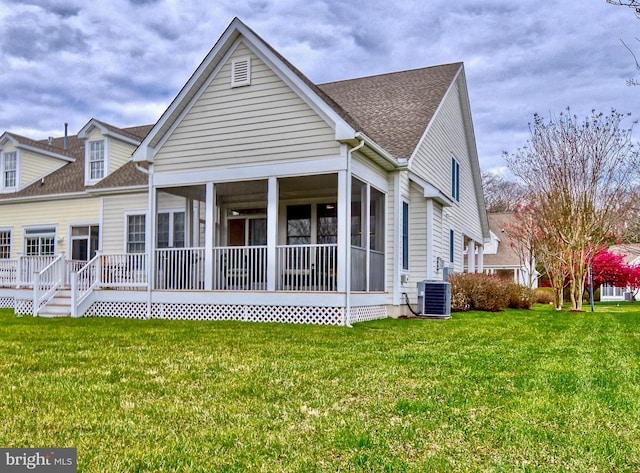 back of house featuring central air condition unit, a yard, and a sunroom