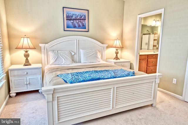 carpeted bedroom with ensuite bathroom