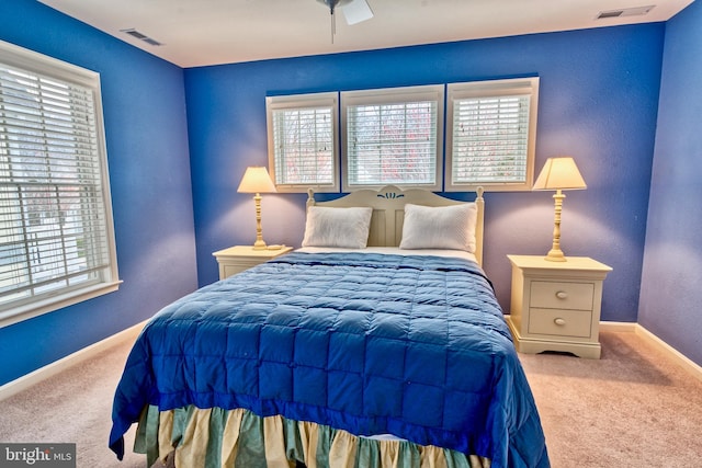 bedroom featuring carpet flooring and multiple windows