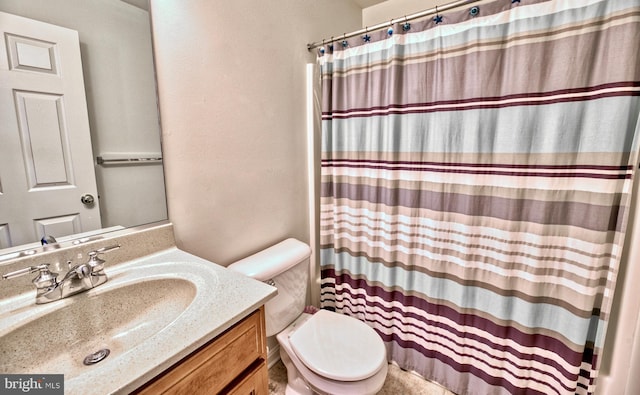 bathroom with vanity, toilet, and curtained shower