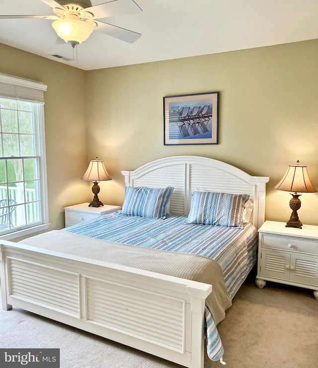 bedroom featuring ceiling fan and light carpet