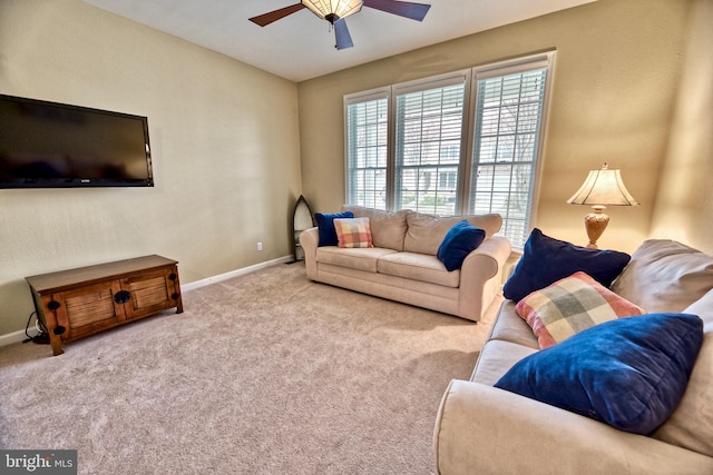 carpeted living room with ceiling fan